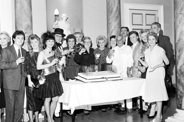 Jenners staff can be seen here as they gather around a cake to celebrate the 150th anniversary of the store trading. Year: 1988