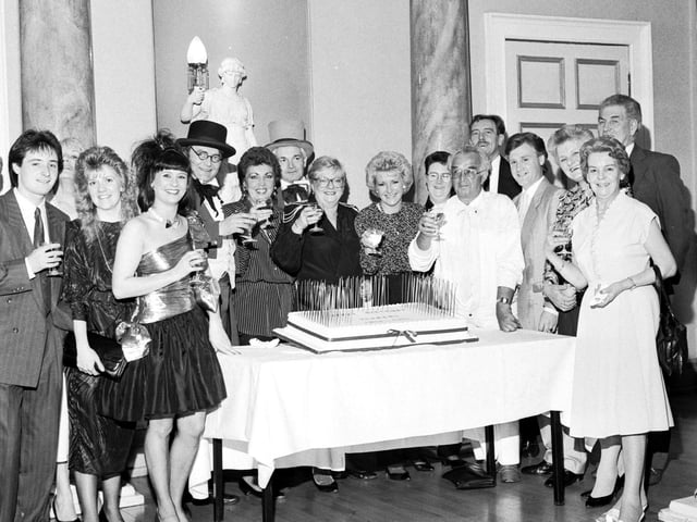 Jenners staff can be seen here as they gather around a cake to celebrate the 150th anniversary of the store trading. Year: 1988