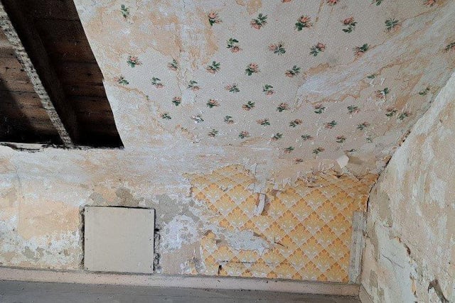 The flat has some original fittings including a porcelain sink and scraps of floral wallpaper.