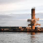 The 600ft chimney at the site of Scotland's last remaining coal fired power station came down this morning.