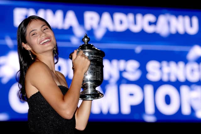 Emma Raducanu poses with the championship trophy after her historic US Open victory in New York. (Photo by Matthew Stockman/Getty Images)