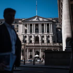 People walk past the Bank of England and the Royal Exchange in London, the centre of the UK's financial services industry (Picture: Carl Court/Getty Images)