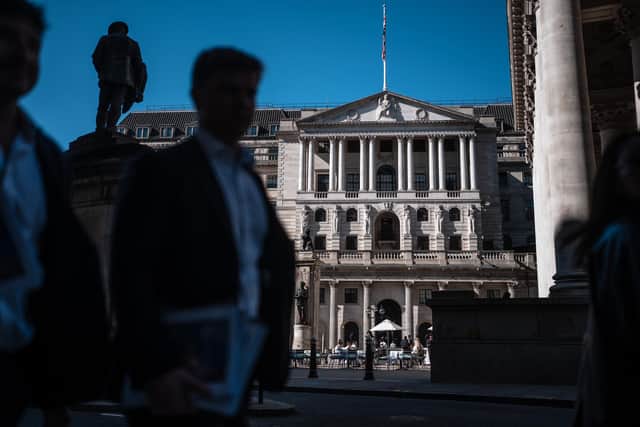 People walk past the Bank of England and the Royal Exchange in London, the centre of the UK's financial services industry (Picture: Carl Court/Getty Images)