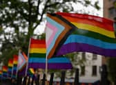 The much more inclusive New Pride Flag which integrates the Trans Pride Flag along with a black and brown stripe for People of Colour. (Photo by ANGELA WEISS/AFP via Getty Images)
