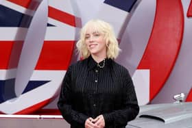 Billie Eilish stands next to James Bonds Aston Martin car at the No Time To Die World Premiere last month. Photo credit: Tim P. Whitby.