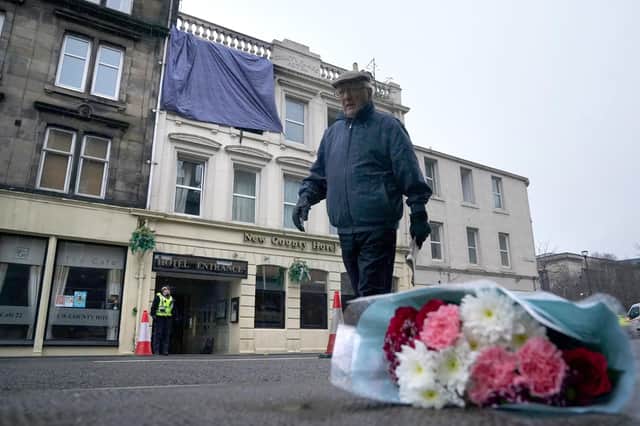 Flowers left at the scene following a fire at the New County Hotel in Perth in which three people died.