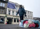 Flowers left at the scene following a fire at the New County Hotel in Perth in which three people died.