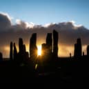The sun rises behind the Calanais Standing Stones on the Isle Of Lewis. PIC:  ANDY BUCHANAN/AFP via Getty Images)