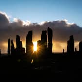 The sun rises behind the Calanais Standing Stones on the Isle Of Lewis. PIC:  ANDY BUCHANAN/AFP via Getty Images)