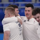 Britain's athletes celebrate after winning the men's curling semifinal match against the United States at the Beijing Winter Olympics Thursday, Feb. 17, 2022, in Beijing. (AP Photo/Brynn Anderson)