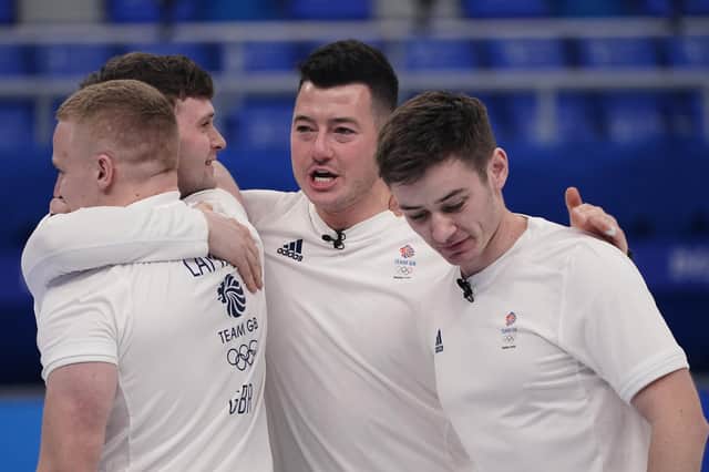 Britain's athletes celebrate after winning the men's curling semifinal match against the United States at the Beijing Winter Olympics Thursday, Feb. 17, 2022, in Beijing. (AP Photo/Brynn Anderson)