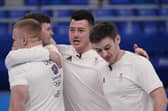 Britain's athletes celebrate after winning the men's curling semifinal match against the United States at the Beijing Winter Olympics Thursday, Feb. 17, 2022, in Beijing. (AP Photo/Brynn Anderson)
