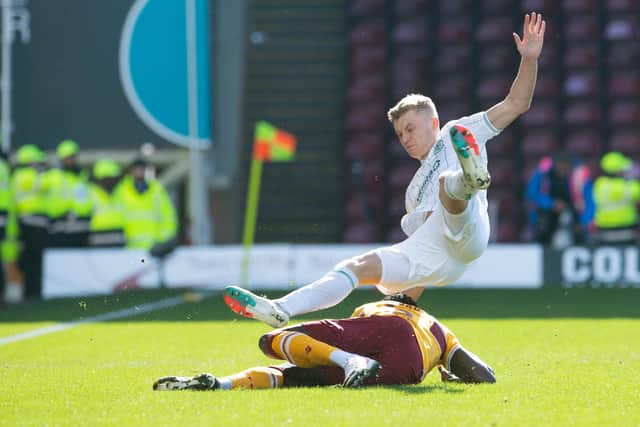 Motherwell's Bevis Mugabi was sent off for this tackle on Hibs' Josh Doig.