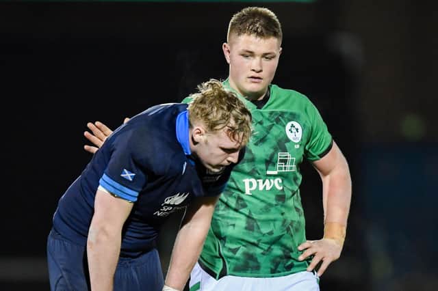 Scotland's Johnny Rutherford is consoled at full time by an Irish counterpart after the heavy loss at Scotstoun.