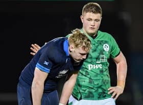 Scotland's Johnny Rutherford is consoled at full time by an Irish counterpart after the heavy loss at Scotstoun.