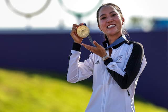 New Zealand's Lydia Ko shows off her gold medal at Le Golf National in Paris on Saturday. Picture: Pierre-Philippe Marcou/AFP via Getty Images.