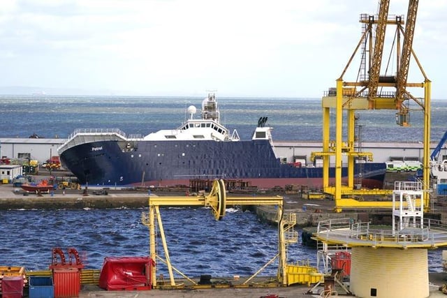 A ship has become dislodged from its holding and is partially toppled over.