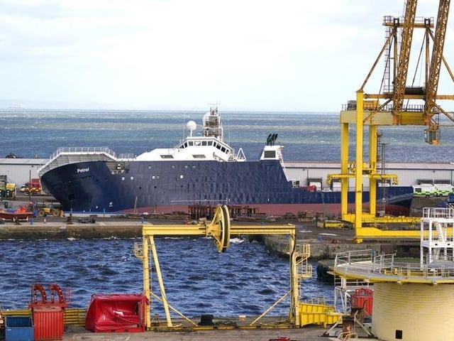 A ship has become dislodged from its holding and is partially toppled over.