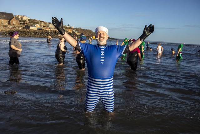 Over one hundred people take part in the Kinghorn Loony Dook New Years Day swim on the Fife coast of the Firth of Forth,
