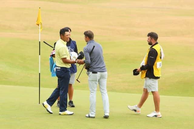 David Law and 2021 Masters champion Hideki Matsuyama shake hands at the end of their round in the 150th Open. Picture: Andrew Redington/Getty Images.