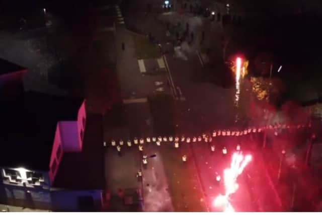 Police officers are targeted with fireworks in Niddrie, Edinburgh, during chaotic scenes on Bonfire Night