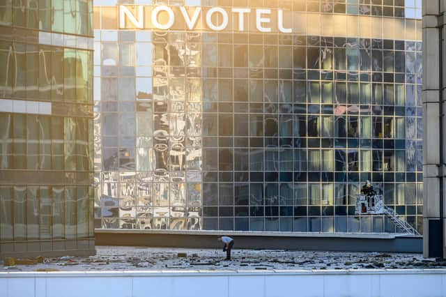 Investigators examine an area next to a damaged building in the "Moscow City" business district after a reported drone attack in Moscow, early on Tuesday.