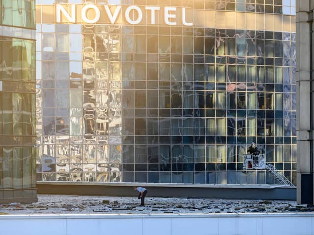 Investigators examine an area next to a damaged building in the "Moscow City" business district after a reported drone attack in Moscow, early on Tuesday.