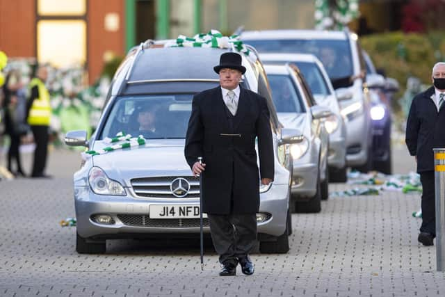 Celtic fans pay respect as Former Celtic player Bertie Auld's funeral cortege passes Celtic Park. Picture: Ross MacDonald/SNS Group