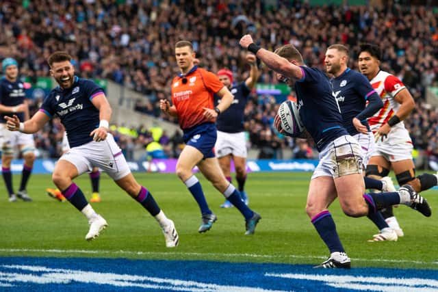 Stuart Hogg raises his arm in triumph as he scores against Japan to break the Scotland try record. (Photo by Ross Parker / SNS Group)