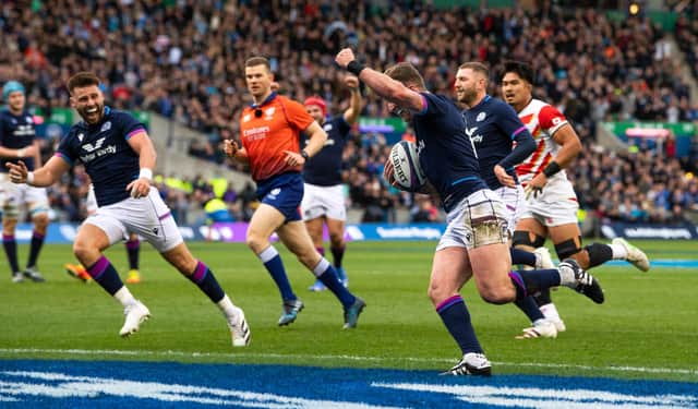 Stuart Hogg raises his arm in triumph as he scores against Japan to break the Scotland try record. (Photo by Ross Parker / SNS Group)