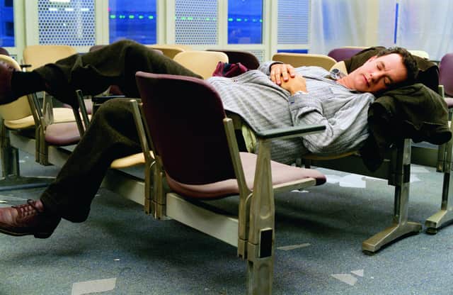Tom Hanks makes himself comfortable during his stay in an airport in New York in The Terminal