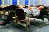 Tom Hanks makes himself comfortable during his stay in an airport in New York in The Terminal