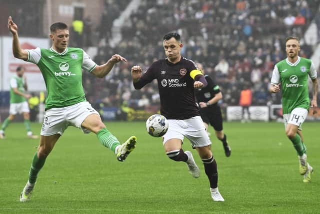 Hibs' Will Fish tries to keep Hearts captain Lawrence Shankland in check.