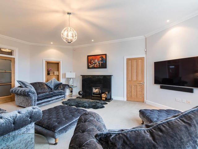 The lounge has a bespoke fireplace with multi-fuel stove.