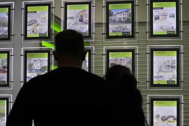 People looking in an estate agent's window, as the average two-year fixed-rate homeowner mortgage on the market has topped 6 per cent for the first time this year. Picture: Yui Mok/PA Wire