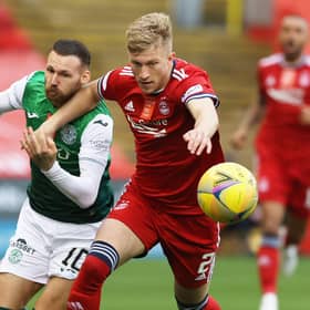 Martin Boyle vies for the ball with Ross McCrorie
