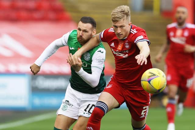 Martin Boyle vies for the ball with Ross McCrorie