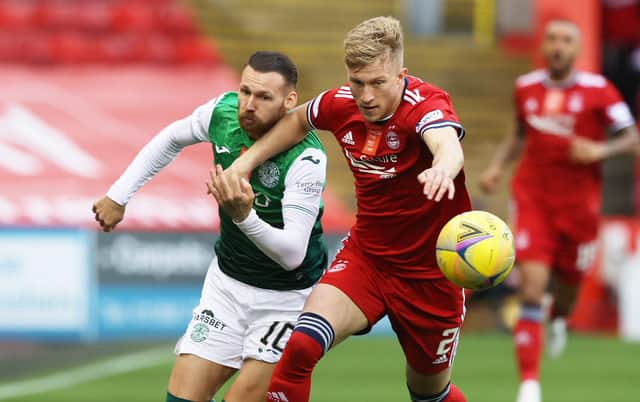 Martin Boyle vies for the ball with Ross McCrorie