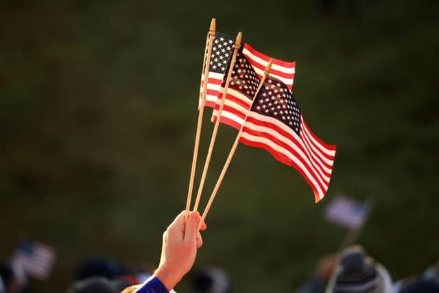 A fan holds American flags during the opening day of the 43rd Ryder Cup at Whistling Straits. Picture: Mike Ehrmann/Getty Images.