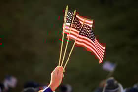 A fan holds American flags during the opening day of the 43rd Ryder Cup at Whistling Straits. Picture: Mike Ehrmann/Getty Images.