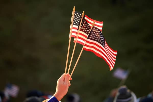 A fan holds American flags during the opening day of the 43rd Ryder Cup at Whistling Straits. Picture: Mike Ehrmann/Getty Images.
