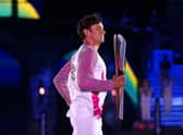 Tom Daley carries the Queen’s Baton during the Opening Ceremony of the Birmingham 2022 Commonwealth Games at Alexander Stadium in Birmingham (Picture: Elsa/Getty Images)