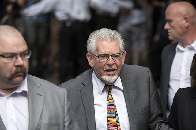 Artist and TV presenter Rolf Harris (centre) arrives at Southwark Crown Court to face sentencing in 2014. Picture: Oli Scarff/Getty Images