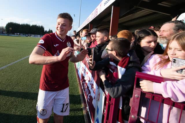 Goalscorer Maksym Kucheriavyi, who hails from Ukraine, celebrates with Kelty Hearts fans after scoring the goal that clinched the League 2 title. (Photo by Ross MacDonald / SNS Group)