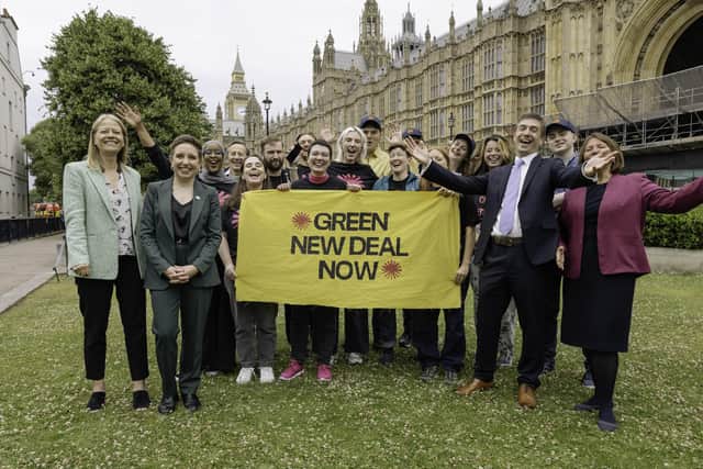 The Green Party's four new MPs celebrate with activists from Green New Deal Rising on College Green.