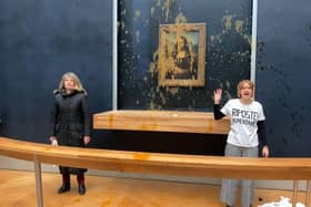 Two environmental activists from the collective dubbed "Riposte Alimentaire" (Food Retaliation) stand in front of Leonardo Da Vinci's "Mona Lisa" painting after hurling soup at the artwork, at the Louvre museum in Paris.