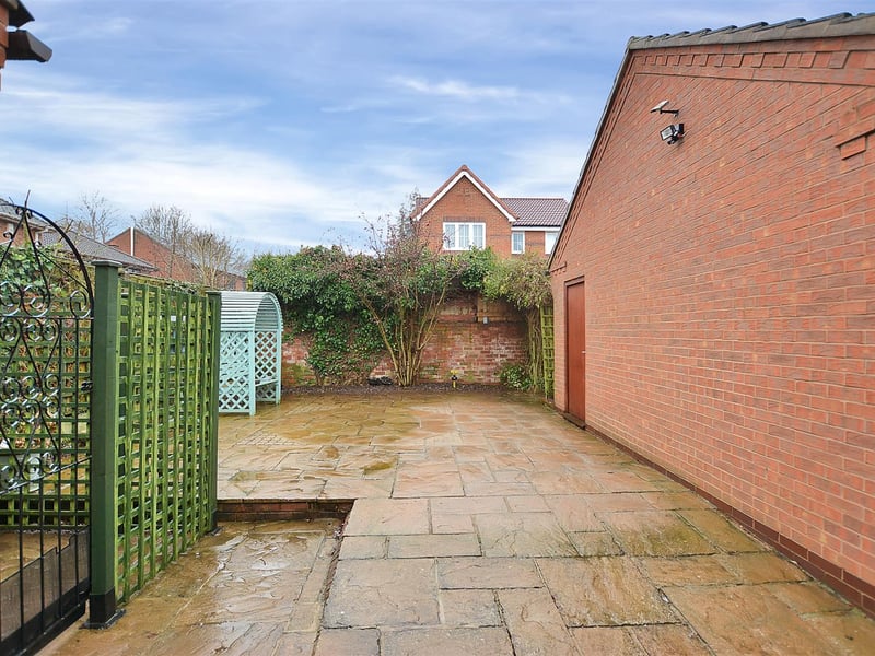 There is a substantial paved patio area to the side of the garage which is big enough to house a caravan.
