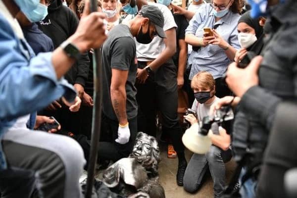 The statue of Edward Colston on the ground after it was pulled down by Black Lives Matter activists