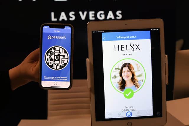 A smartphone and an iPad demonstrate a digital vaccine passport that can show the results of a recent Covid test or vaccination (Picture: Ethan Miller/Getty Images)