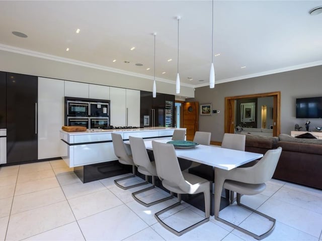 Kitchen/dining/family room. The kitchen is fitted with a range of units and surfaces and latest appliances, as well as a double sink with boiling water tap and waste disposer.